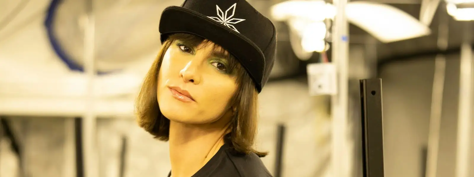 Woman in a cap in a cannabis grow room
